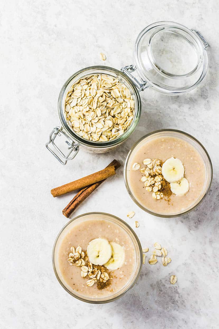 Scorched Peanut Smoothie with peanuts oats and garnished with banana on a light marble background